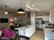 Spacious kitchen with an oversized island, stainless steel appliances, and an adjacent dining area at 6539 W Briles Rd, Phoenix, AZ 85083