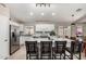 Bright, modern kitchen features stainless steel appliances and an expansive island with seating at 6539 W Briles Rd, Phoenix, AZ 85083