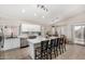 Spacious kitchen with white cabinetry, an island with bar seating, and stainless steel appliances at 6539 W Briles Rd, Phoenix, AZ 85083