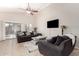 Comfortable living room features tile floors, neutral paint, large windows, and stylish furnishings at 6539 W Briles Rd, Phoenix, AZ 85083
