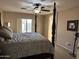 Comfortable primary bedroom with a ceiling fan and natural light from the sliding glass doors at 6539 W Briles Rd, Phoenix, AZ 85083