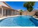 View of the backyard swimming pool surrounded by lush landscaping and privacy fencing at 6539 W Briles Rd, Phoenix, AZ 85083