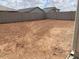 Large backyard ready for landscaping and outdoor enjoyment, surrounded by a block fence for privacy at 7417 E Hackamore Ln, San Tan Valley, AZ 85143