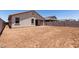 Spacious backyard enclosed by a block wall, featuring dirt ground cover and views of the home at 7417 E Hackamore Ln, San Tan Valley, AZ 85143