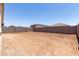 Spacious backyard featuring dirt ground cover enclosed by a concrete block wall offering privacy at 7417 E Hackamore Ln, San Tan Valley, AZ 85143