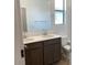 Bathroom featuring double sinks, sleek cabinetry, modern fixtures and an open window at 7417 E Hackamore Ln, San Tan Valley, AZ 85143