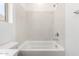 Bright bathtub with tile surround, brushed fixtures, and a white toilet at 7417 E Hackamore Ln, San Tan Valley, AZ 85143