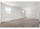 Bright bedroom featuring neutral carpet, and multiple windows at 7417 E Hackamore Ln, San Tan Valley, AZ 85143