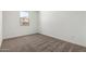 Bright bedroom with neutral carpeting and a window at 7417 E Hackamore Ln, San Tan Valley, AZ 85143
