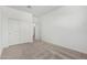 Bedroom features neutral carpeting, a closet, and access to a hallway at 7417 E Hackamore Ln, San Tan Valley, AZ 85143