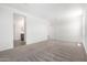 Spacious primary bedroom with neutral carpet, bright lighting, and attached bathroom at 7417 E Hackamore Ln, San Tan Valley, AZ 85143