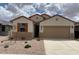 Charming single-story home featuring desert landscaping, a two-car garage and neutral paint scheme at 7417 E Hackamore Ln, San Tan Valley, AZ 85143