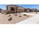 Charming single-story home with a two-car garage, low-maintenance landscaping, and a welcoming front entrance at 7417 E Hackamore Ln, San Tan Valley, AZ 85143