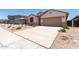 Charming single-story home with a two-car garage, low-maintenance landscaping, and a welcoming front entrance at 7417 E Hackamore Ln, San Tan Valley, AZ 85143