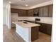 Modern kitchen with stainless steel appliances, quartz countertops, and rich wood cabinetry at 7417 E Hackamore Ln, San Tan Valley, AZ 85143