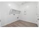 Bright laundry room with tile floors, overhead shelving, and utility hookups for appliances at 7417 E Hackamore Ln, San Tan Valley, AZ 85143