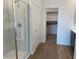 Luxurious main bathroom featuring a glass-enclosed shower, walk-in closet and stylish tile flooring at 7417 E Hackamore Ln, San Tan Valley, AZ 85143
