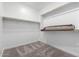 Bright walk-in closet offers ample storage space with shelving and hanging rods at 7417 E Hackamore Ln, San Tan Valley, AZ 85143