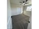 This bedroom has neutral colored carpet, window with decorative bars, and a ceiling fan at 7637 E Akron St, Mesa, AZ 85207