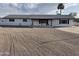 Charming single-story home with white paint, black trim, and gravel landscaping at 7637 E Akron St, Mesa, AZ 85207