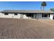 Charming single-story home with white paint, black trim, and gravel landscaping at 7637 E Akron St, Mesa, AZ 85207