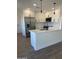 Modern kitchen features white cabinets, stainless steel appliances, and an eat-in island at 7637 E Akron St, Mesa, AZ 85207