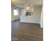 Open-concept kitchen with white cabinets, stainless appliances, and a large eat-in island at 7637 E Akron St, Mesa, AZ 85207