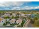 Aerial view of a golf course community with lush greenery and blue lakes and desert accents at 7678 E Cactus Wren Rd, Scottsdale, AZ 85250