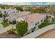 Rear aerial view of property with a lush backyard, and a large grassy space at 7678 E Cactus Wren Rd, Scottsdale, AZ 85250