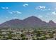 Aerial view highlights the vibrant community with mountain views in the distance at 7678 E Cactus Wren Rd, Scottsdale, AZ 85250