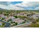 Wide aerial perspective of the neighborhood showing the surrounding green landscape and mountains at 7678 E Cactus Wren Rd, Scottsdale, AZ 85250