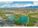 Expansive aerial showing a large golf course, with multiple water features, surrounded by homes at 7678 E Cactus Wren Rd, Scottsdale, AZ 85250