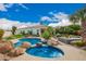 Beautiful backyard with pool, spa, patio area, and lush landscaping; perfect for outdoor living at 7678 E Cactus Wren Rd, Scottsdale, AZ 85250