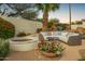 Cozy backyard with outdoor seating around firepit and colorful flowers, creating a relaxing space at 7678 E Cactus Wren Rd, Scottsdale, AZ 85250