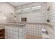 Luxurious walk-in shower boasts dual shower heads and unique decorative tile surround at 7678 E Cactus Wren Rd, Scottsdale, AZ 85250