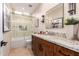 Elegant bathroom featuring tub/shower combo, granite counters, and stylish fixtures at 7678 E Cactus Wren Rd, Scottsdale, AZ 85250