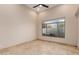 Bright bedroom featuring stone tile flooring and a large window, providing plenty of light at 7678 E Cactus Wren Rd, Scottsdale, AZ 85250