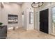 Inviting entryway with neutral tones, travertine flooring, and elegant lighting at 7678 E Cactus Wren Rd, Scottsdale, AZ 85250