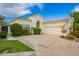 Attractive home exterior featuring a tile roof, desert landscaping, and a spacious three car garage at 7678 E Cactus Wren Rd, Scottsdale, AZ 85250