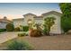 Charming exterior with stucco facade, tile roof, and vibrant desert landscaping at sunset at 7678 E Cactus Wren Rd, Scottsdale, AZ 85250
