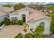 Charming home with well-manicured landscaping, a tile roof, and inviting front entrance at 7678 E Cactus Wren Rd, Scottsdale, AZ 85250