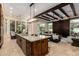 Spacious kitchen featuring a large island, granite countertops, and an open floor plan into the living room at 7678 E Cactus Wren Rd, Scottsdale, AZ 85250