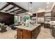 Well-lit kitchen featuring a large island, stainless steel appliances and an open floor plan at 7678 E Cactus Wren Rd, Scottsdale, AZ 85250