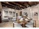 Stylish living space with wood ceilings, a stone fireplace, and comfortable seating near the dining room at 7678 E Cactus Wren Rd, Scottsdale, AZ 85250