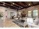 Open-concept living room boasts wood-beamed ceilings, a stone fireplace, and plenty of natural light at 7678 E Cactus Wren Rd, Scottsdale, AZ 85250