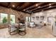 Inviting living space with stone fireplace, wood ceilings, and an elegant dining area at 7678 E Cactus Wren Rd, Scottsdale, AZ 85250