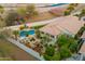 An aerial view of a backyard pool and lush, desert landscaping with multiple seating areas at 7678 E Cactus Wren Rd, Scottsdale, AZ 85250