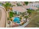 Backyard aerial view featuring a lagoon-style pool, hot tub, and fire pit area for outdoor enjoyment at 7678 E Cactus Wren Rd, Scottsdale, AZ 85250