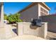 Outdoor kitchen with built in BBQ and nicely landscaped backyard at 7703 E Overlook Dr, Scottsdale, AZ 85255