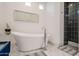 Elegant bathroom features a modern soaking tub, stylish fixtures and a tiled shower at 7703 E Overlook Dr, Scottsdale, AZ 85255